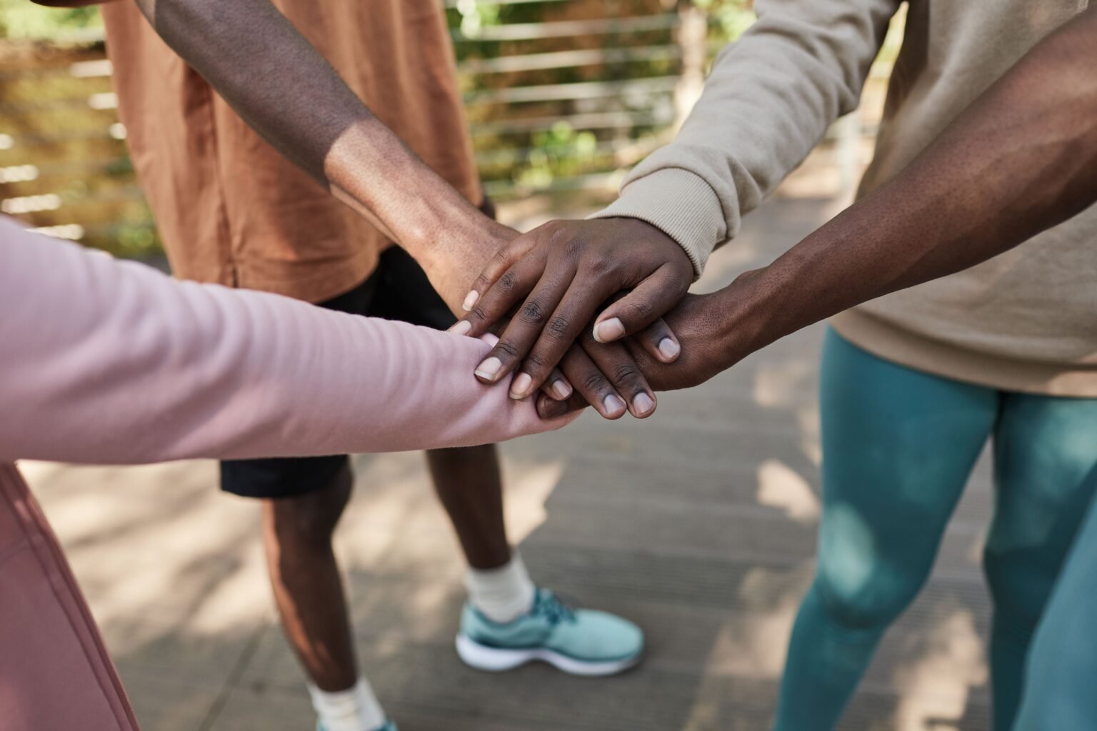 A group of people supporting one another outdoors