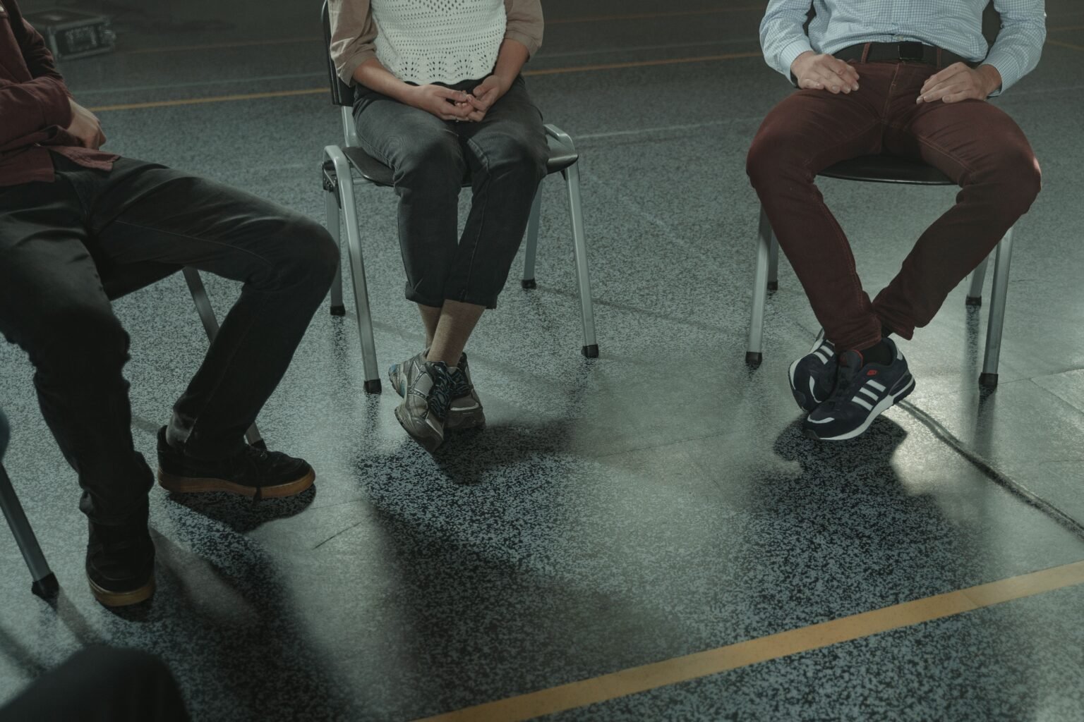 Three adults seated together during a peer support session